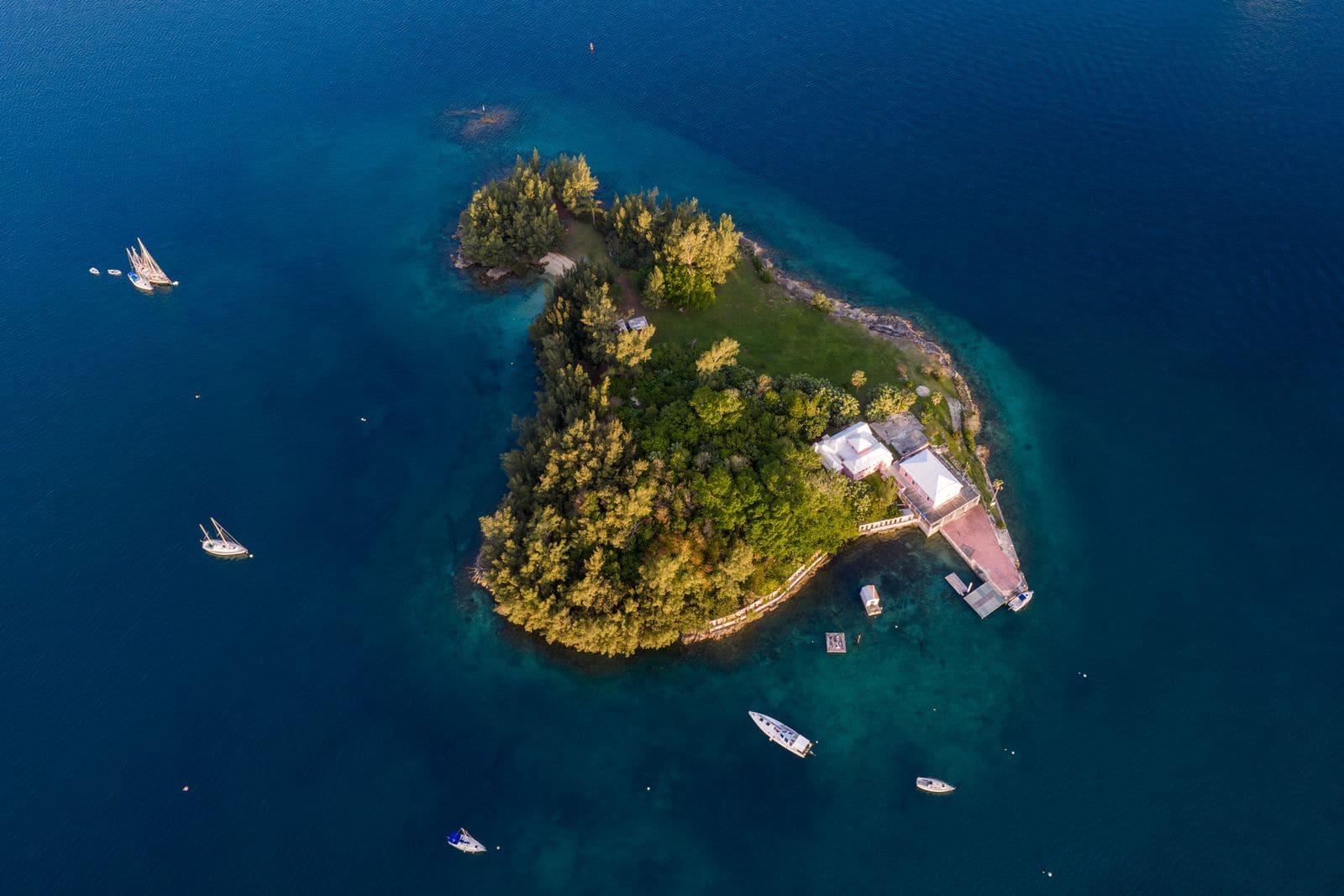 Aerial view of a tropical island with a rugged coastline and sunrise light