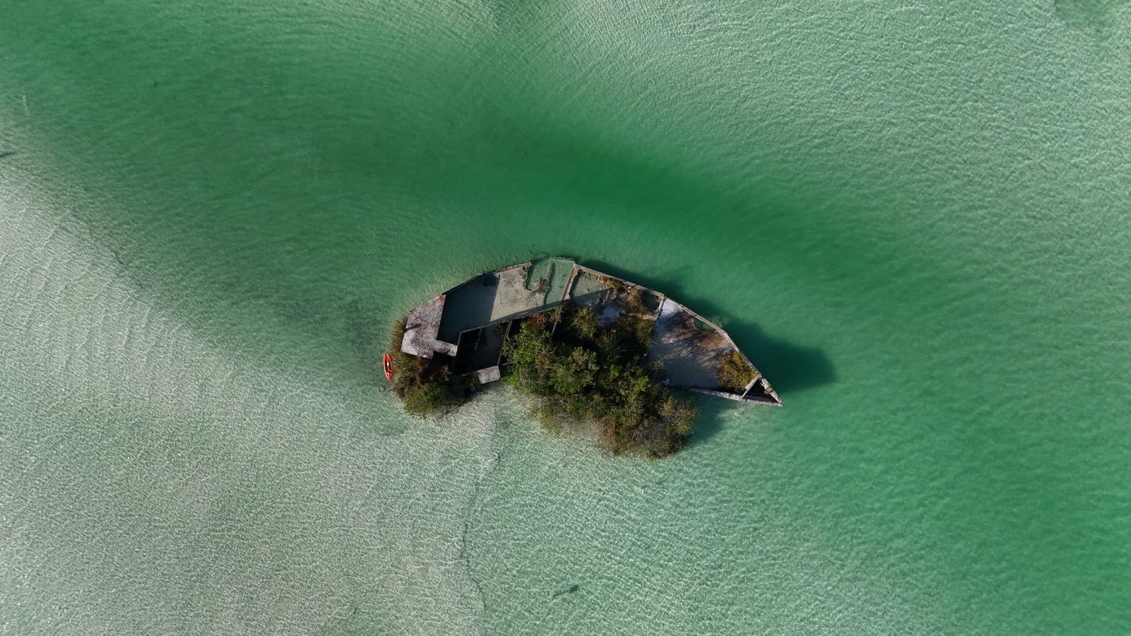Aerial view of a solitary island surrounded by a blue lagoon