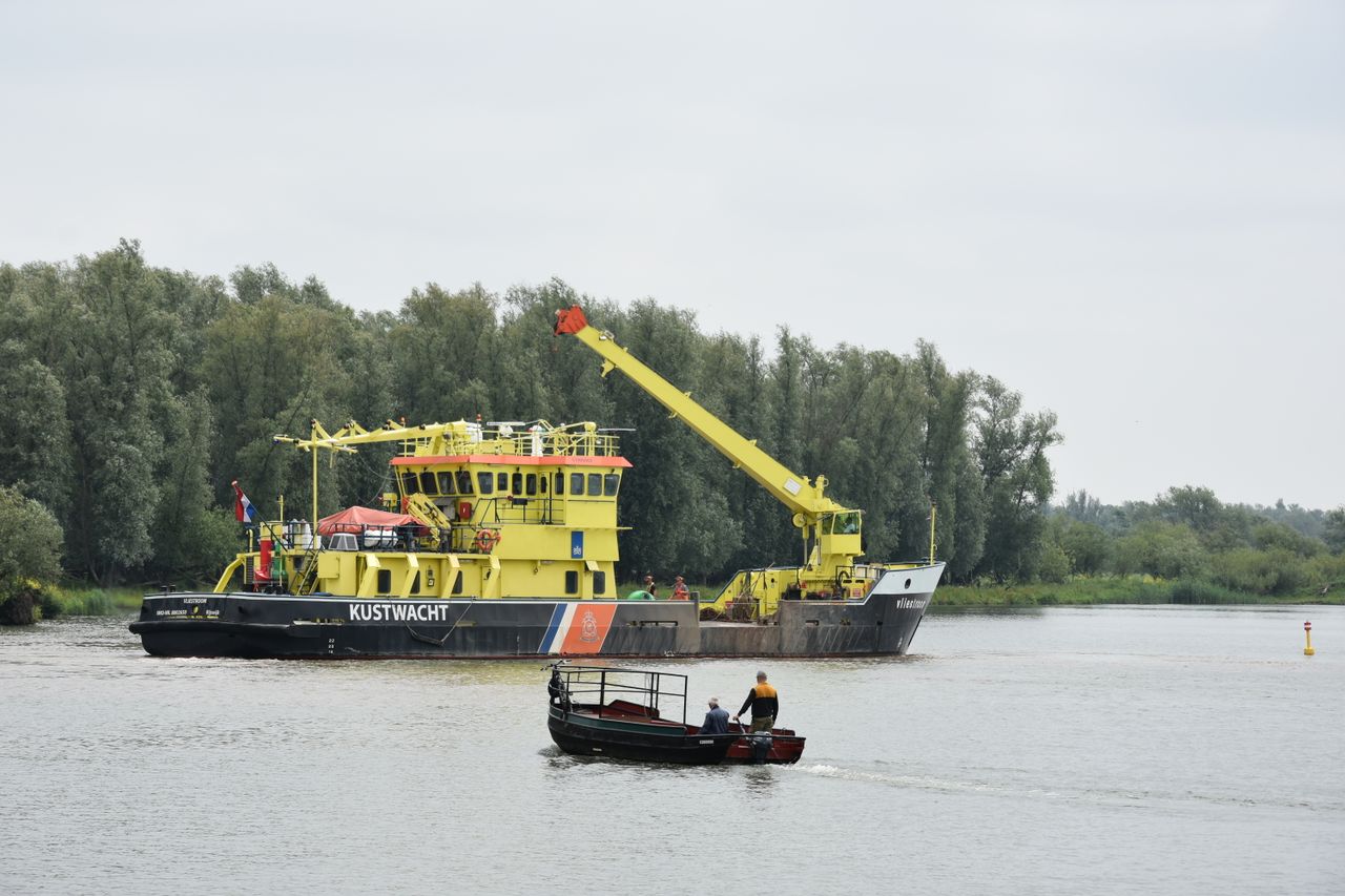 Survey vessel mapping the seabed near an island with sonar equipment